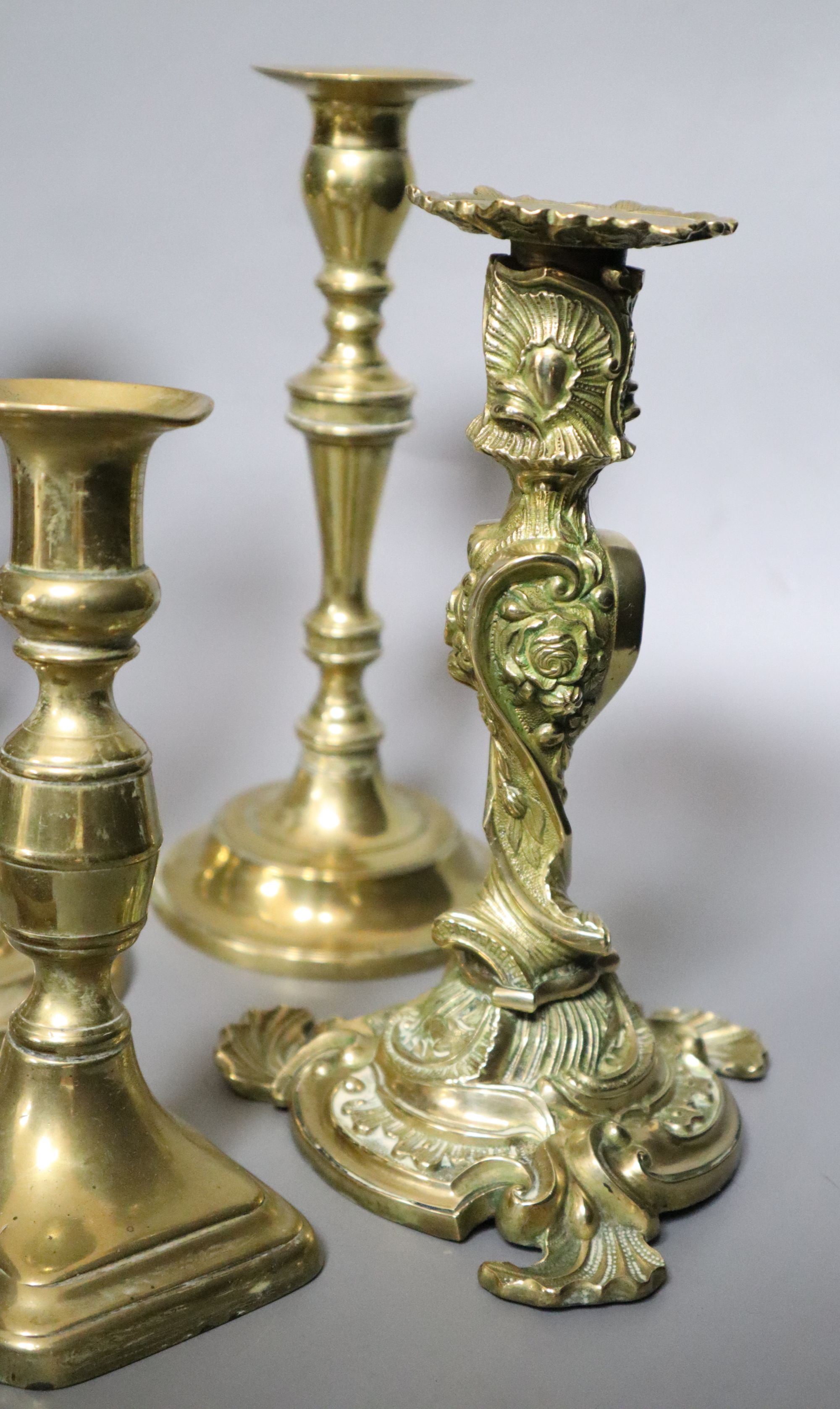 A group of brassware including candlesticks